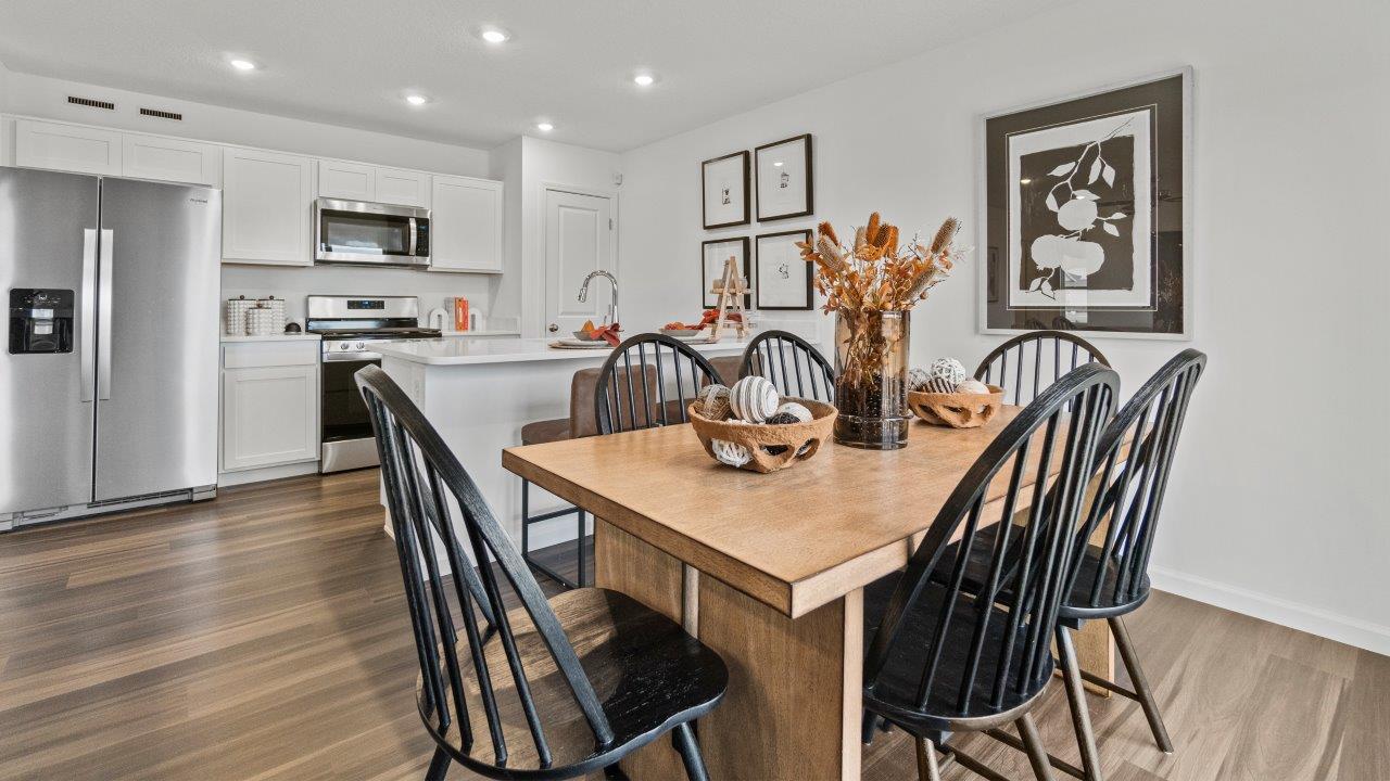 riverwalk aldridge model casual dining room with ryder lvp flooring and sliding glass door to backyard