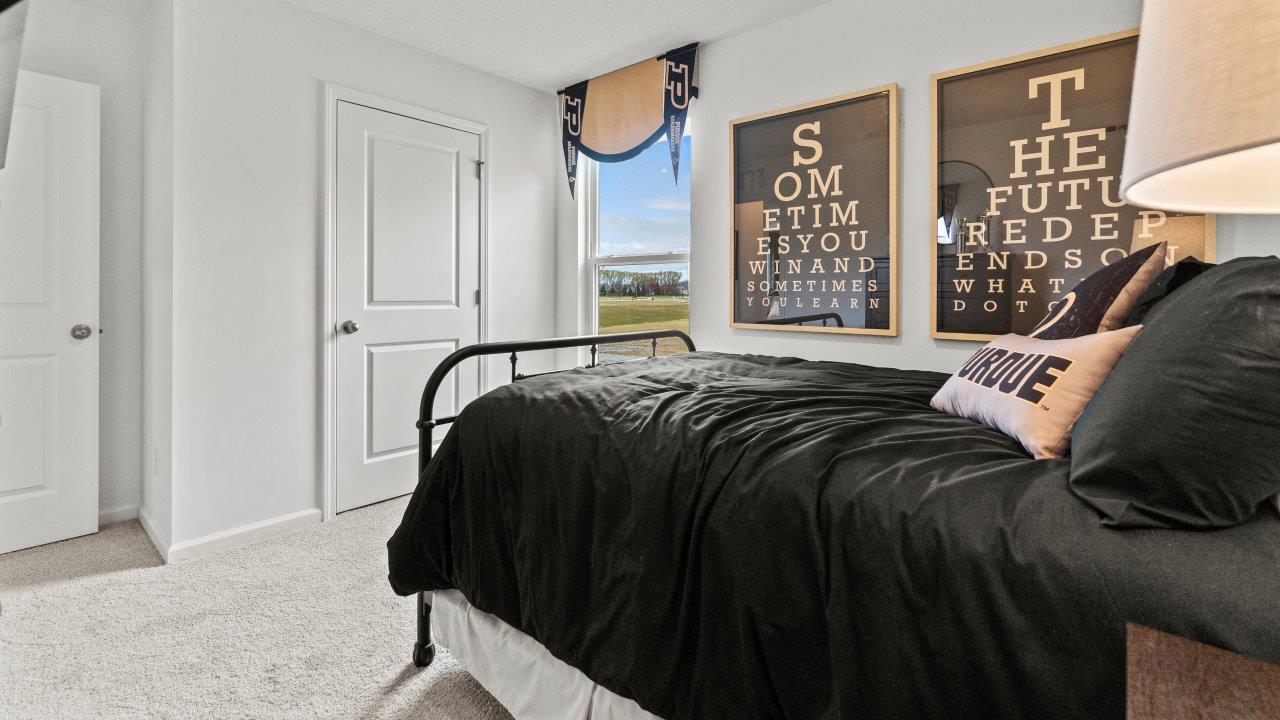 riverwalk aldridge model bedroom 2 with single window, closet, white walls, and elk beige carpet