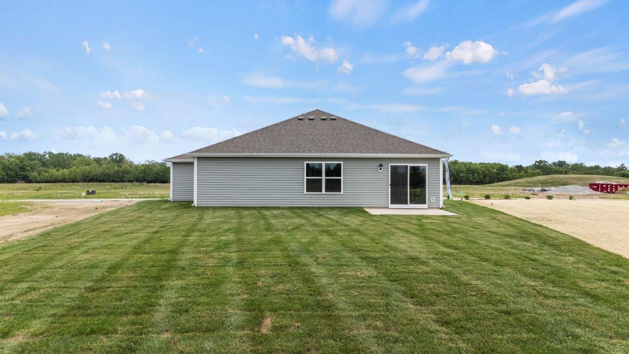 riverwalk aldridge model rear exterior with sodded backyard and concrete patio