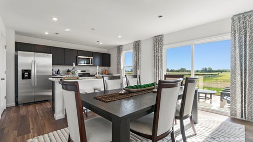 Kennebec Bellamy Model Home Dining room space with sliding glass door leading to back yard and LVP flooring.