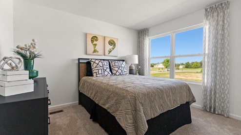 Kennebec Bellamy Model Home Bedroom 1 with 2 windows and carpet flooring.