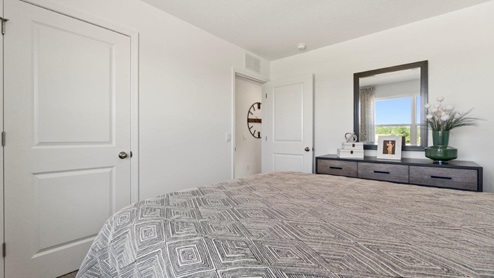 Kennebec Bellamy Model Home Bedroom 1 with closet with plain white walls.