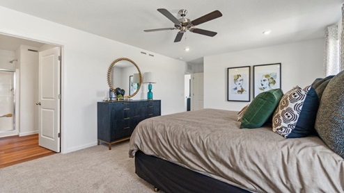 Kennebec Bellamy Model Home Main bedroom with entry to bathroom and closet with carpet and LVP flooring in bathroom.