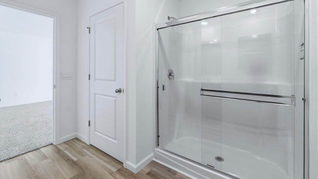 primary ensuite bathroom with dual sinks and walk in shower