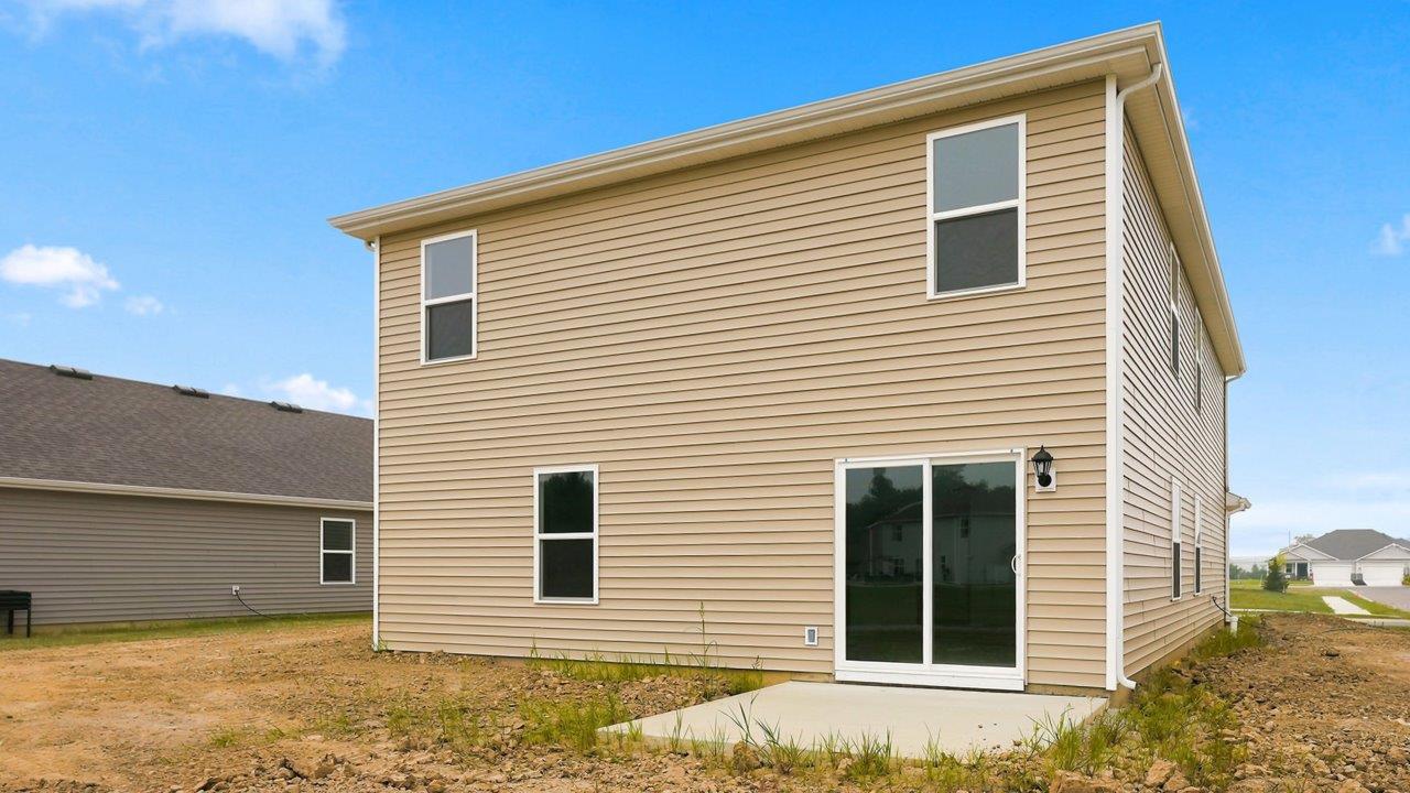 kennebec elm rear exterior with uncovered concrete patio and spacious yard