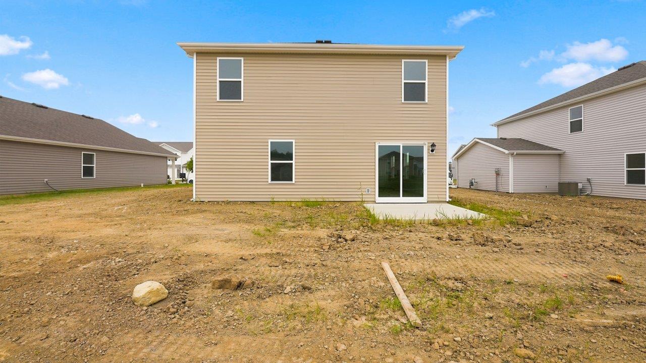 kennebec elm rear exterior with uncovered concrete patio and spacious yard