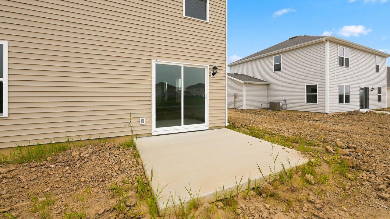 kennebec elm rear exterior with uncovered concrete patio and spacious yard