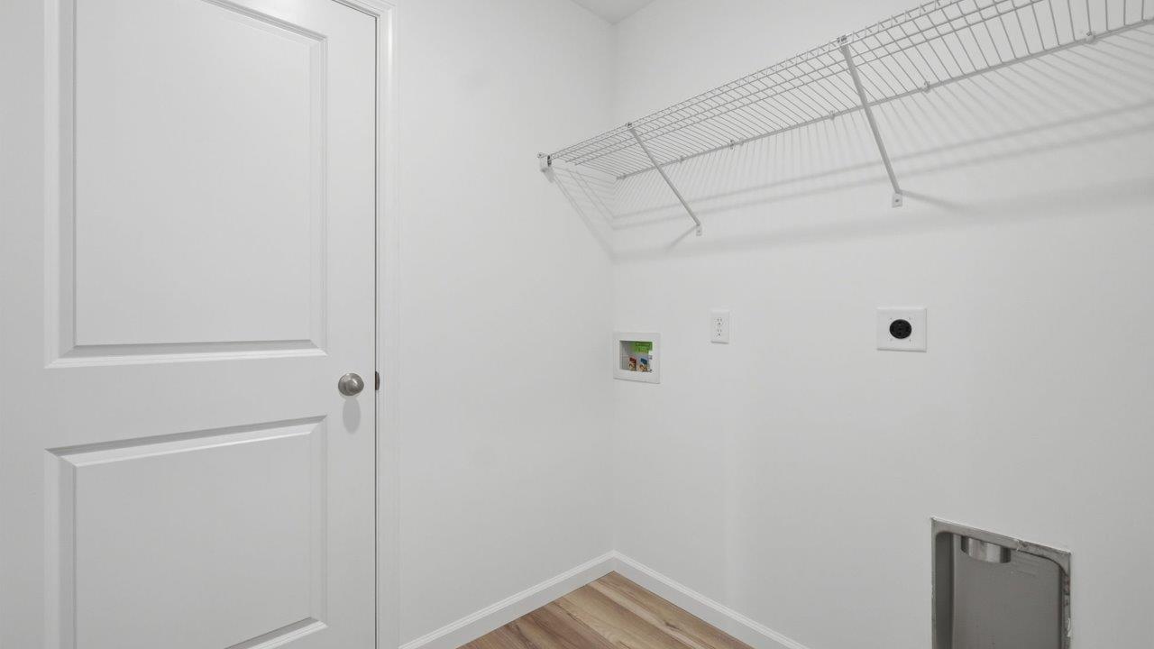 kennebec elm second floor laundry room near bedrooms with hookups, ventilated shelf, and moahwk avery lvp flooring