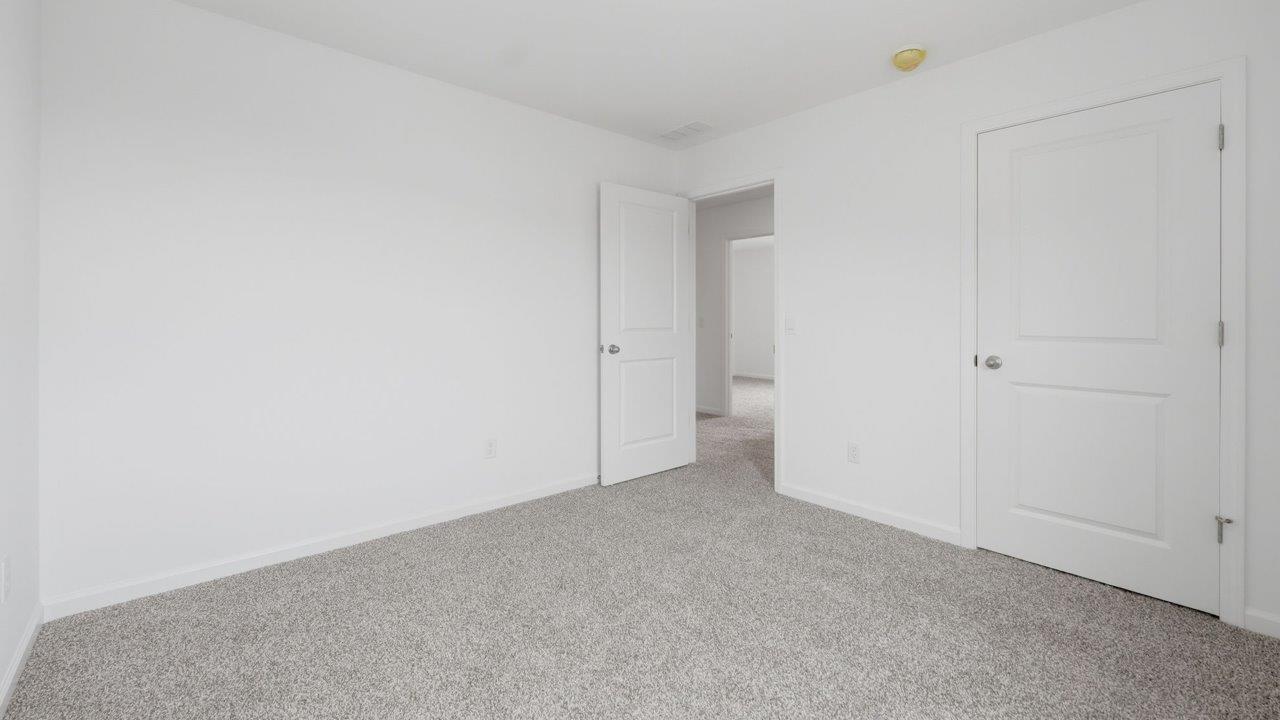 kennebec elm first floor bedroom 5 with carpet flooring, ensuite closet, and nearby full bathroom