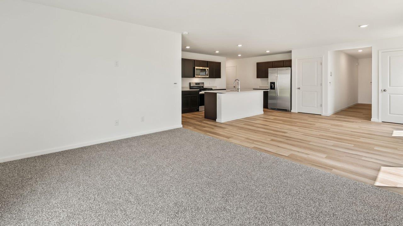 Kennebec Elm C3 - kitchen with sarsaparilla cabinets, quartz countertops, island with bar seating, and stainless steel appliances