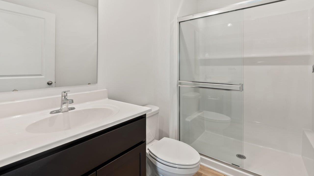 Kennebec Elm C3 - full bathroom with single vanity sink and walk in fiberglass shower