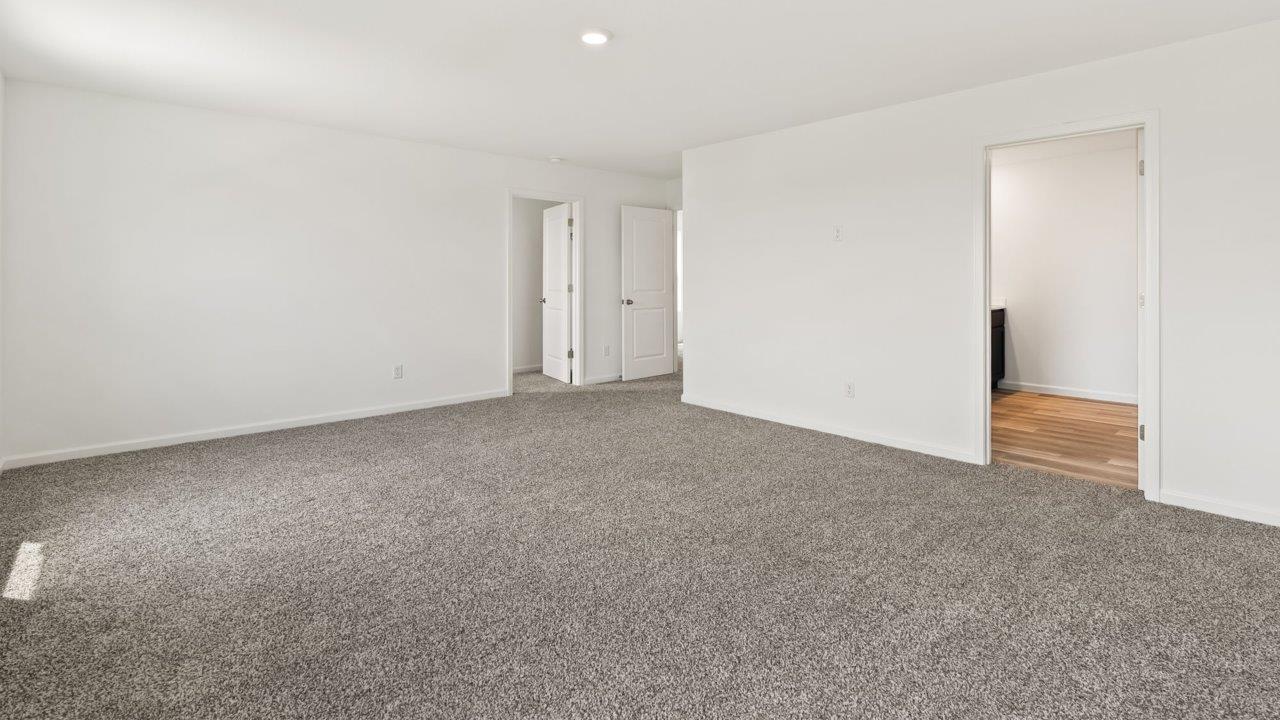 Kennebec Elm C3 - primary bedroom with ensuite bathroom and walk in closet with elk beige carpet flooring and 2 windows