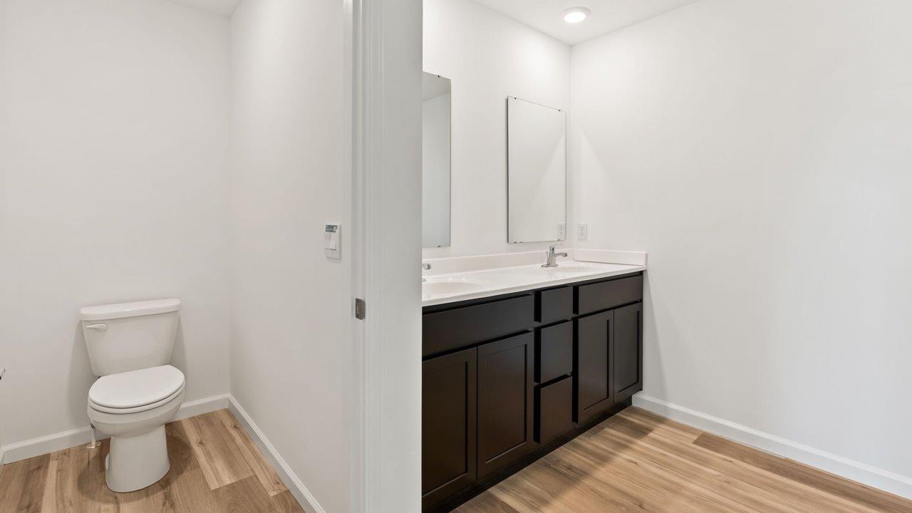 Kennebec Elm C3 - primary bedroom ensuite bathroom with dual sinks, walk in shower, linen closet, and sarsaparilla cabinets