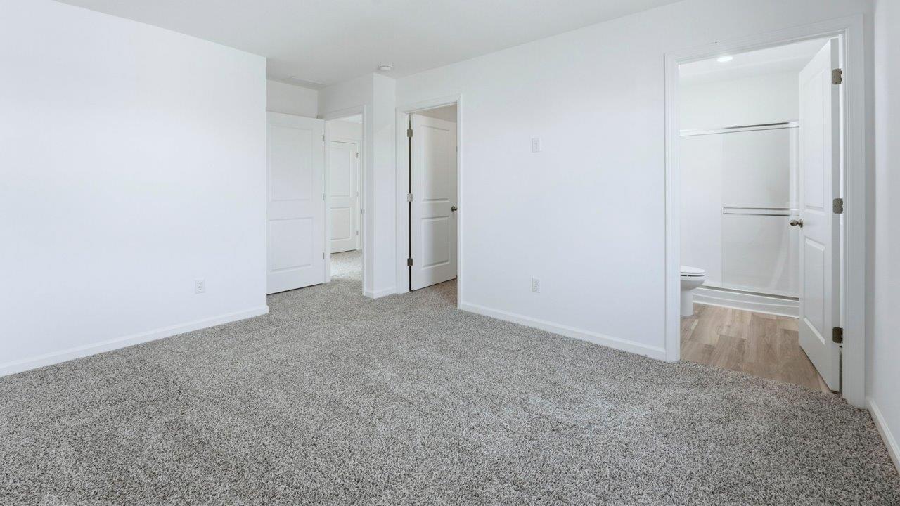 primary bedroom with ensuite bath and walk in closet