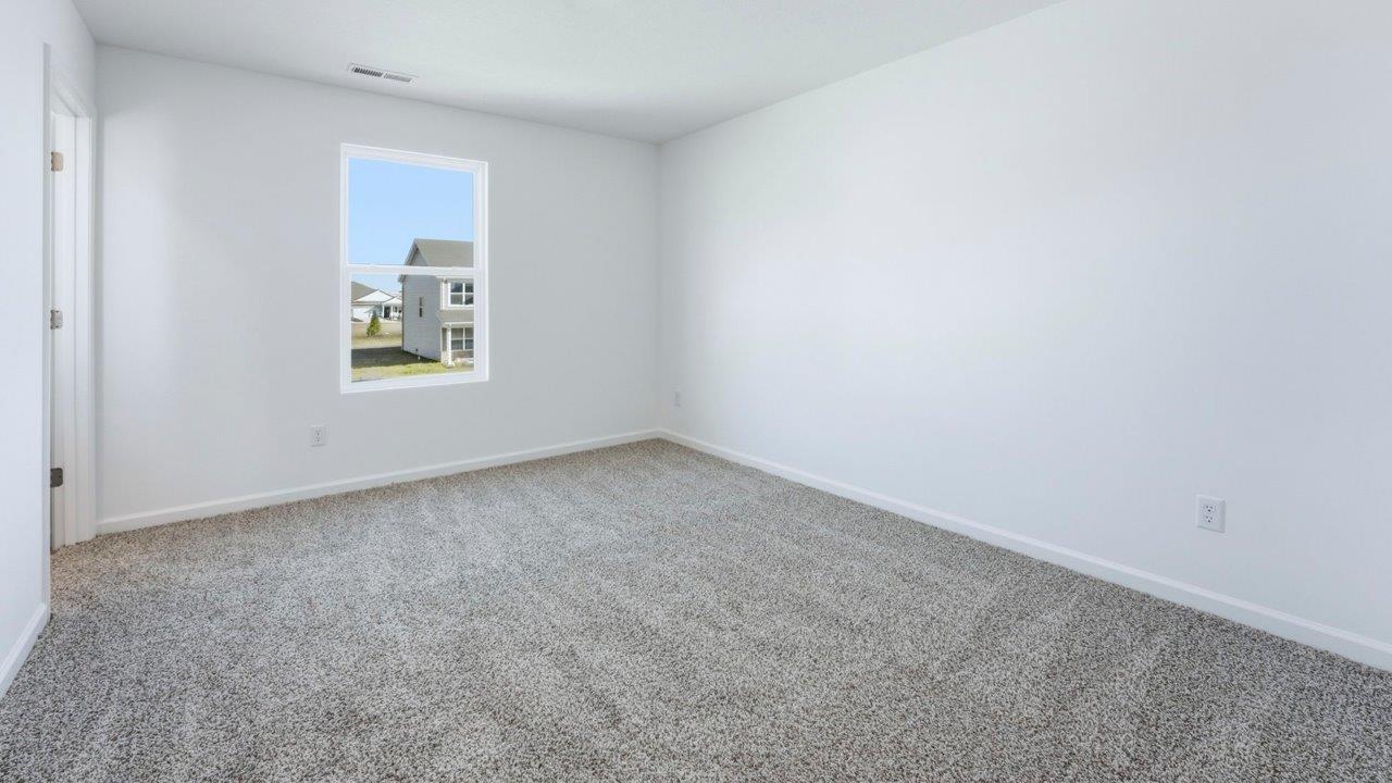 primary bedroom with ensuite bath and walk in closet