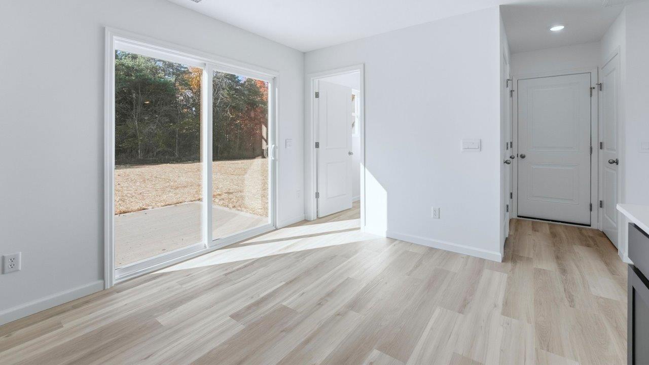 dining space with lvp and sliding door to backyard patio