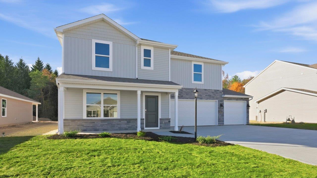 Kennebec Fairton with 3 car garage, sodded yard, and landscaping