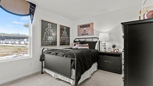 Riverwalk Villas Aldridge Model Home - Bedroom 2 with single window for natural light and small closet.