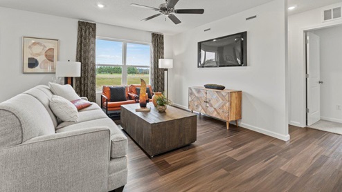Riverwalk Villas Aldridge Model Home - Living room in an open floorplan layout with Ryder LVP flooring.