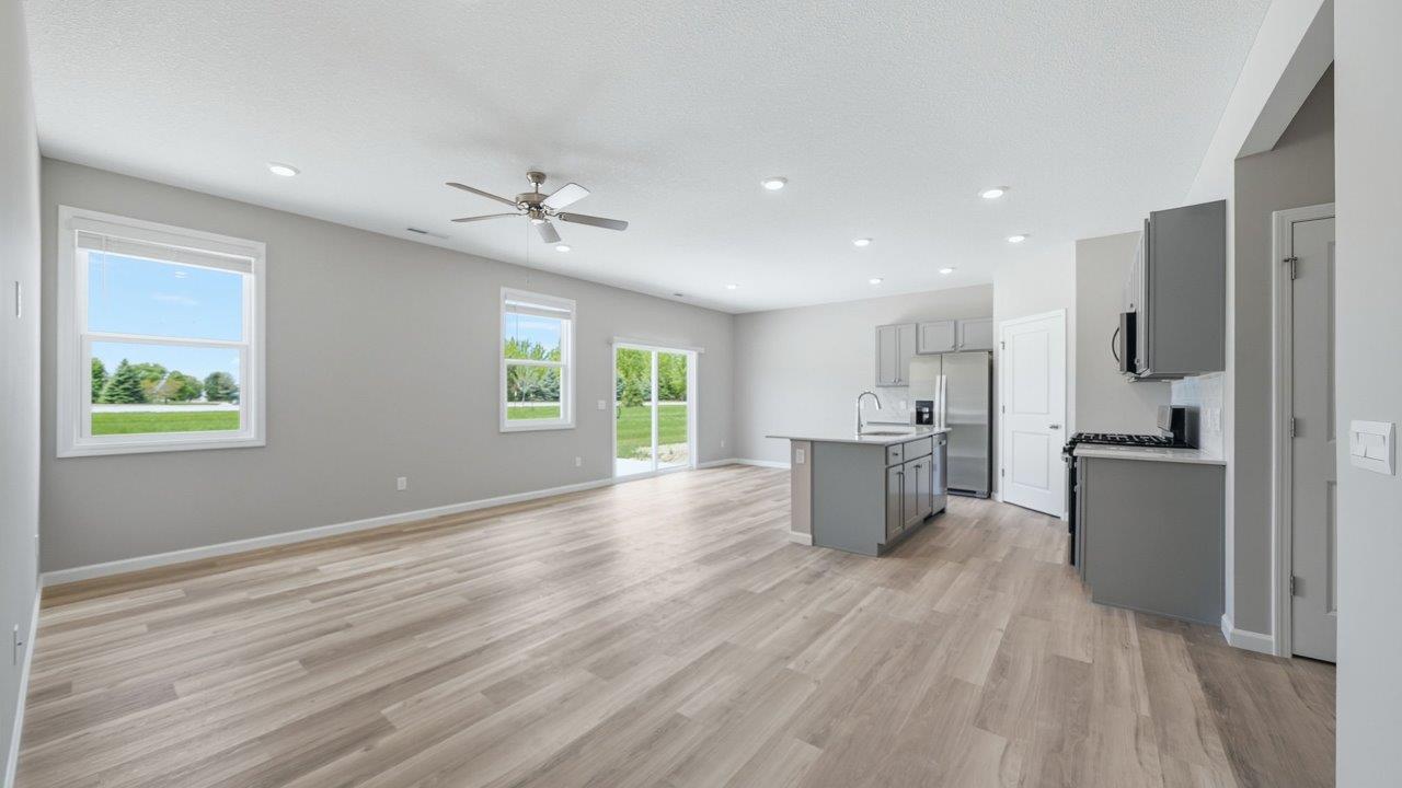 open layout living room, dining space, and kitchen with lvp throughout
