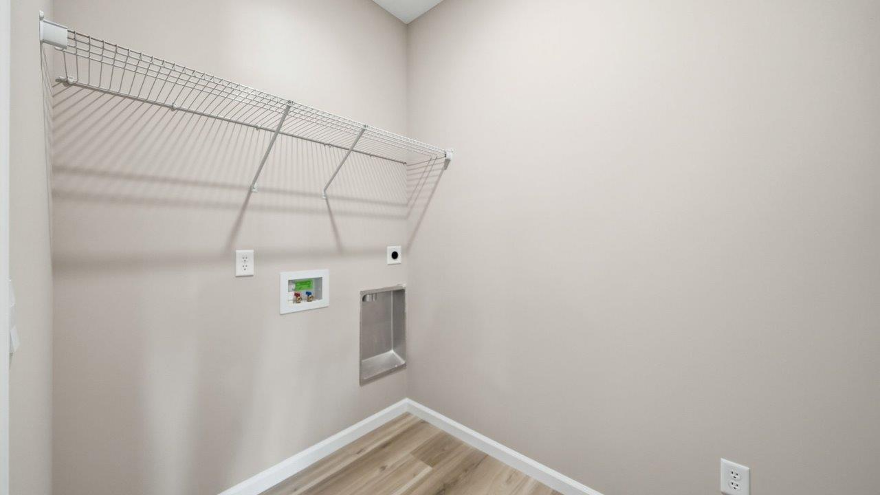 laundry room with lvp flooring and shelving