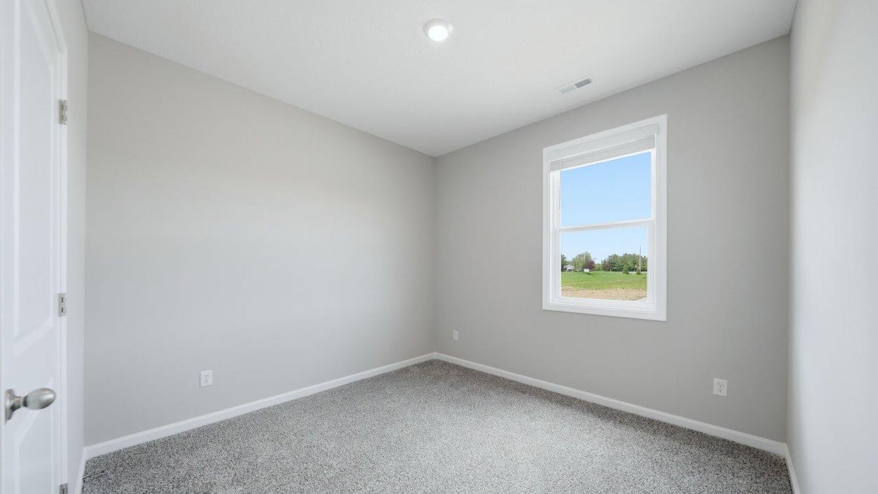 bedroom 2 with carpet flooring, 1 windows, and ensuite closet