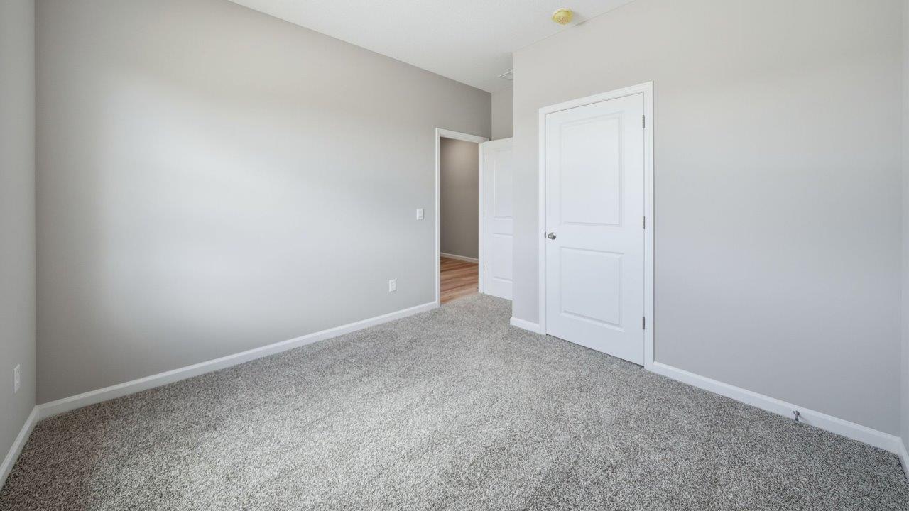 bedroom 2 with carpet flooring, 1 windows, and ensuite closet