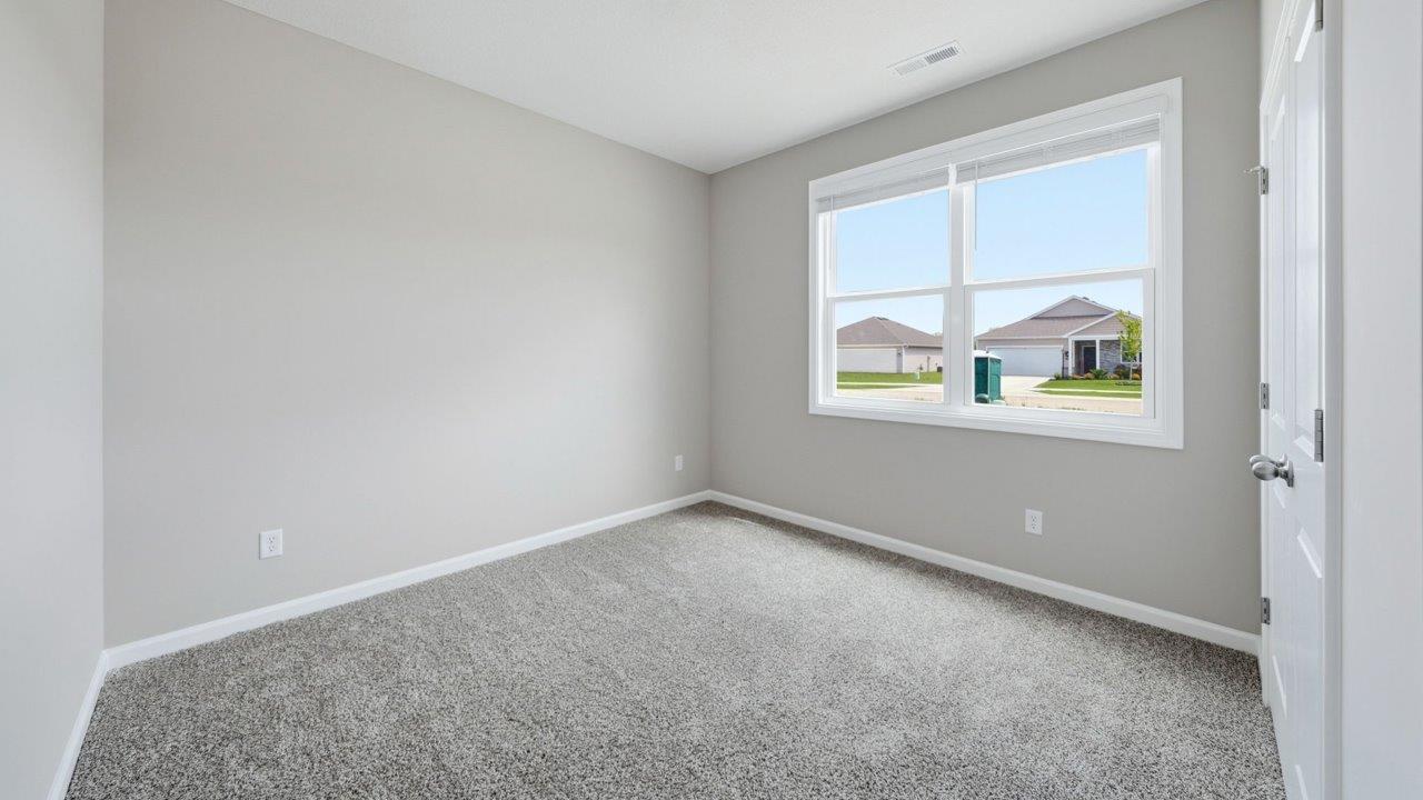bedroom 3 with carpet flooring, 2 windows, and ensuite closet