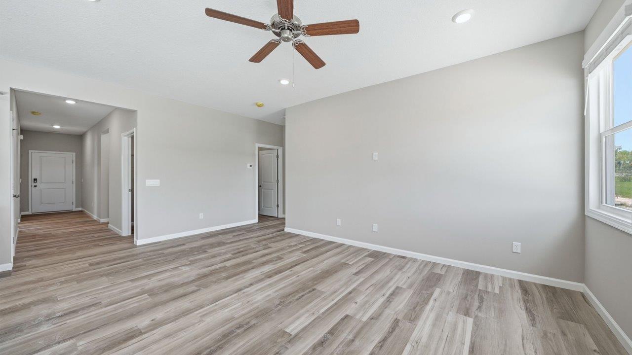 foyer leading into open layout living room with lvp flooring and large windows
