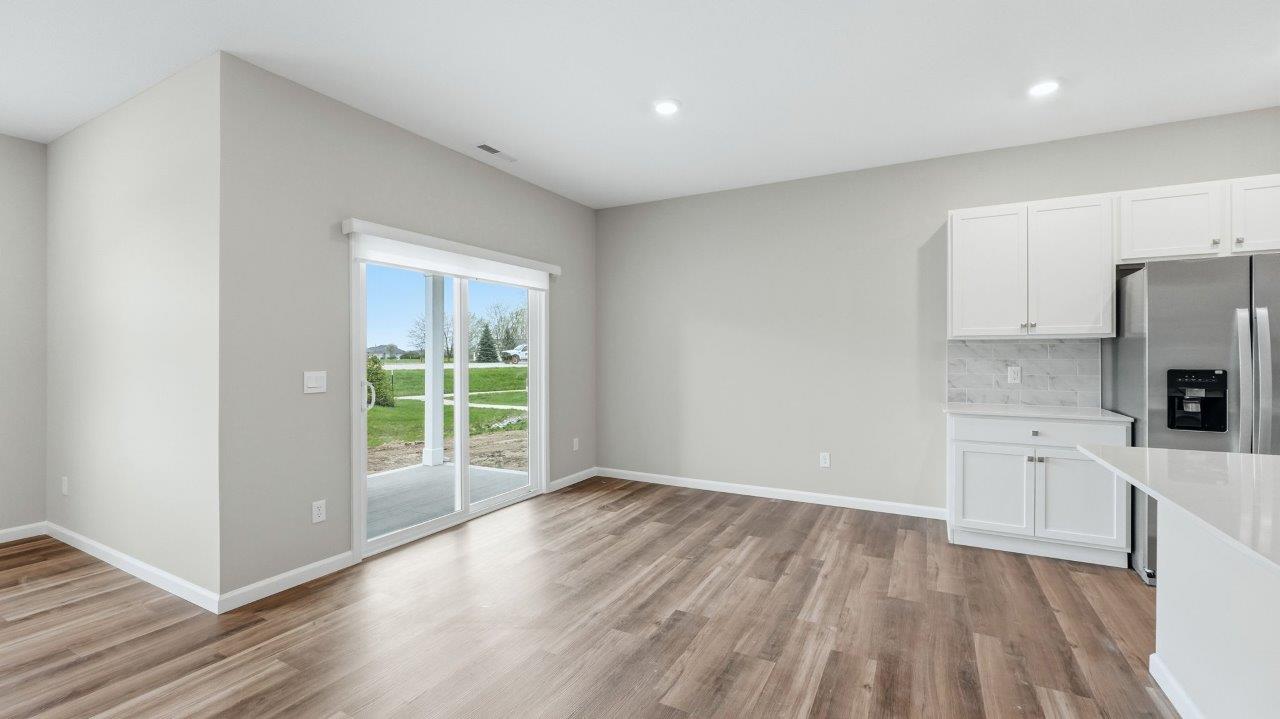 casual dining room with sliding glass door to backyard covered patio and lvp flooring