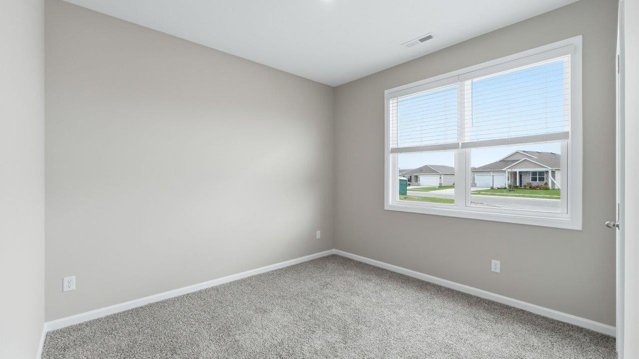 bedroom 2 with carpet, closet, and 2 windows