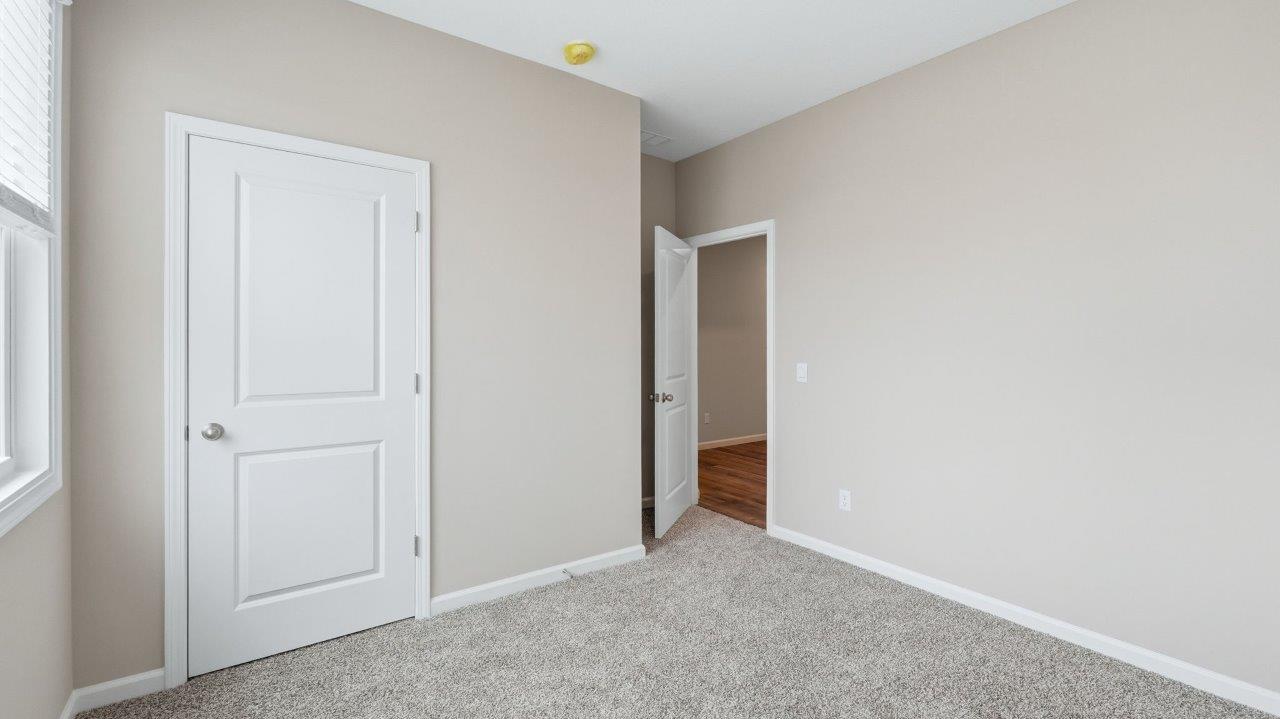 bedroom 2 with carpet, closet, and 2 windows