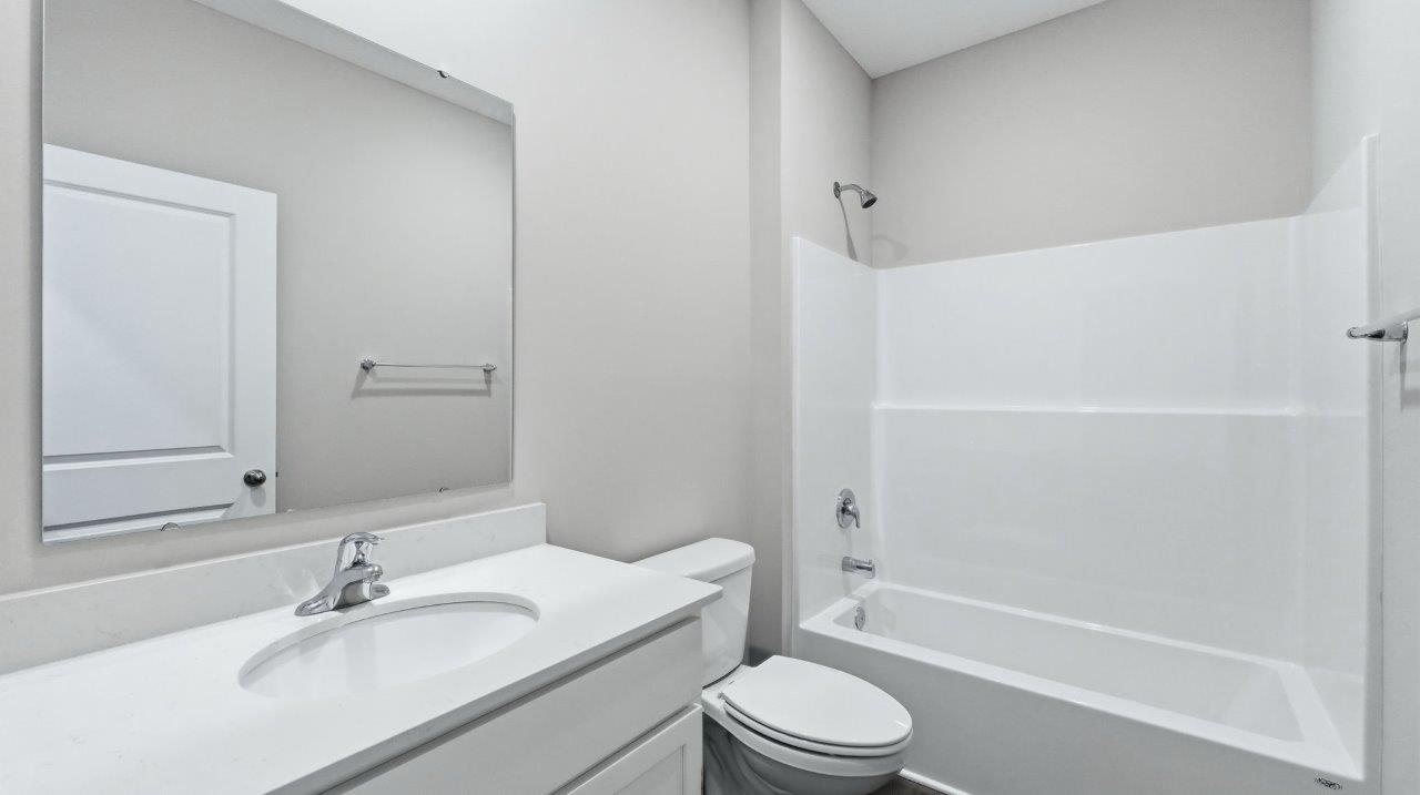 full bathroom with tub shower and single vanity sink