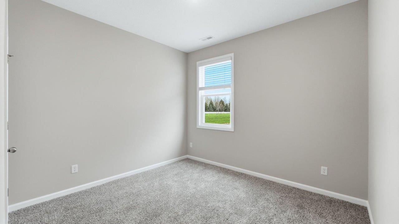 bedroom 3 with carpet, closet, and 2 windows