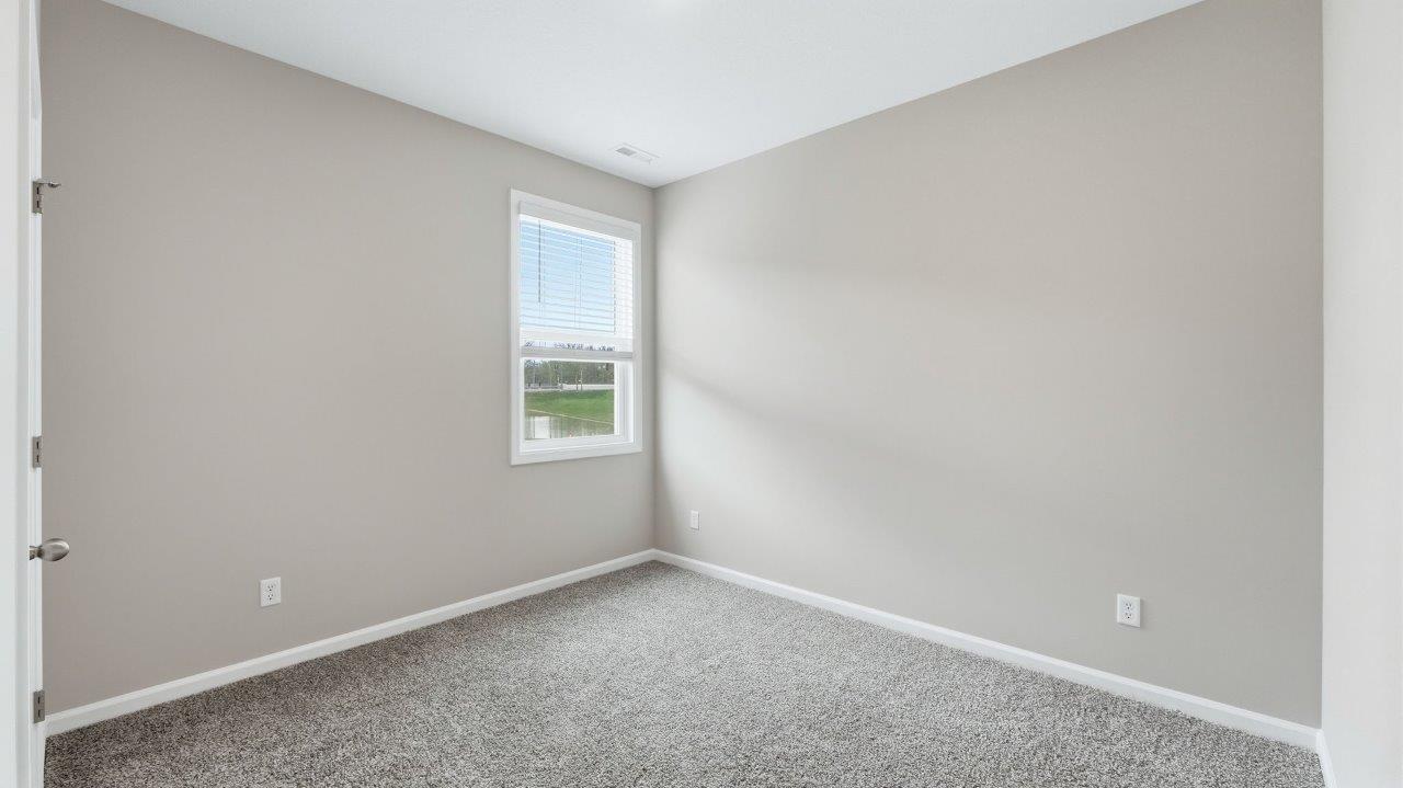 bedroom 4 with carpet, closet, and 2 windows