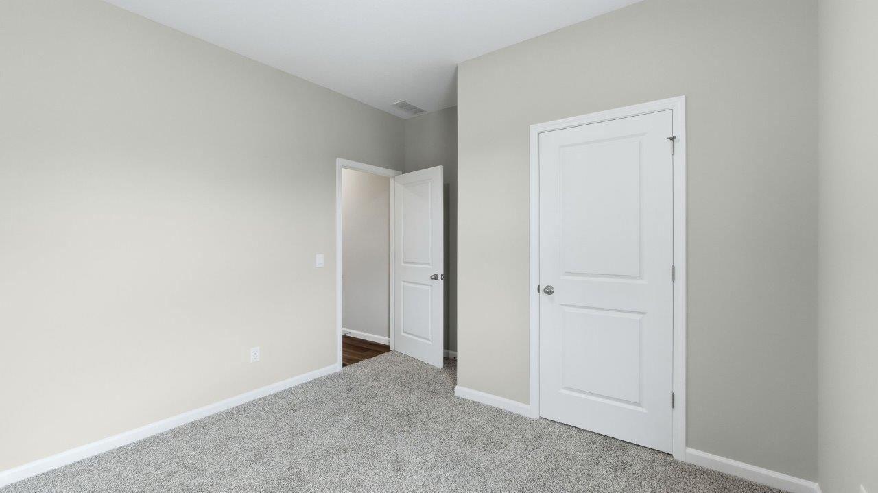 bedroom 4 with carpet, closet, and 2 windows