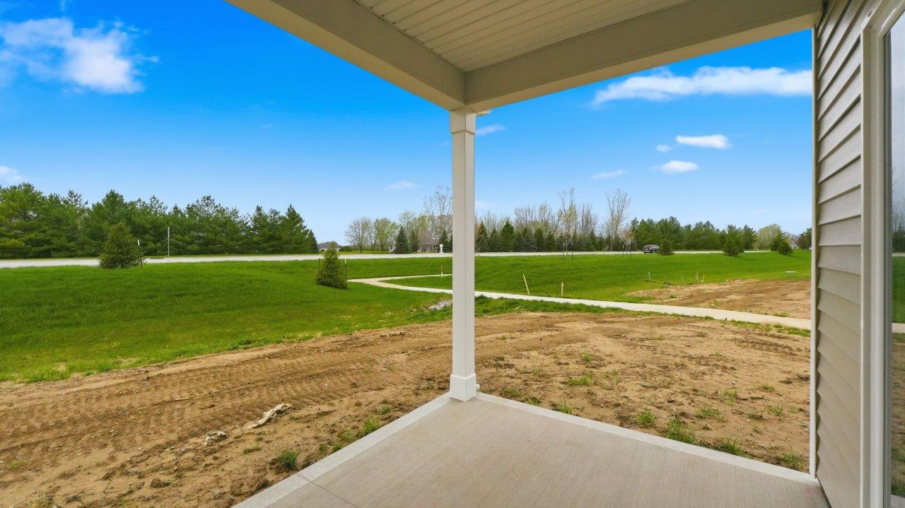 riverwalk villa rear exterior with covered back patio and pond