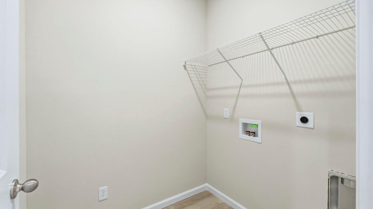 laundry room with shelving, lvp, and hookups