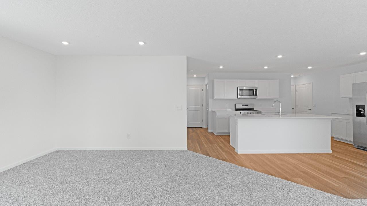 elm living room with carpet flooring and sliding door to backyard