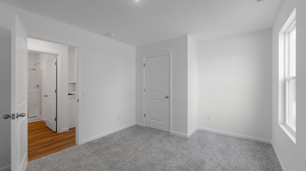 elm first floor bedroom 5 with carpet flooring and closet