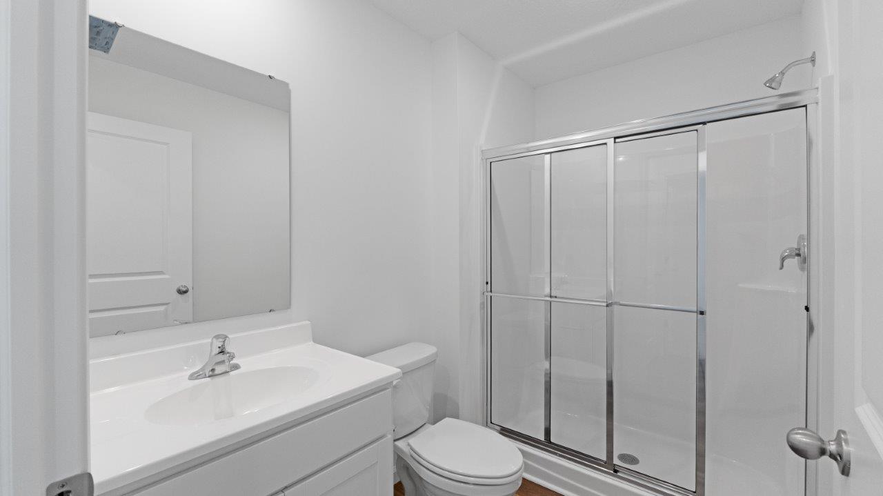 elm full bathroom with walk-in shower and vanity sink