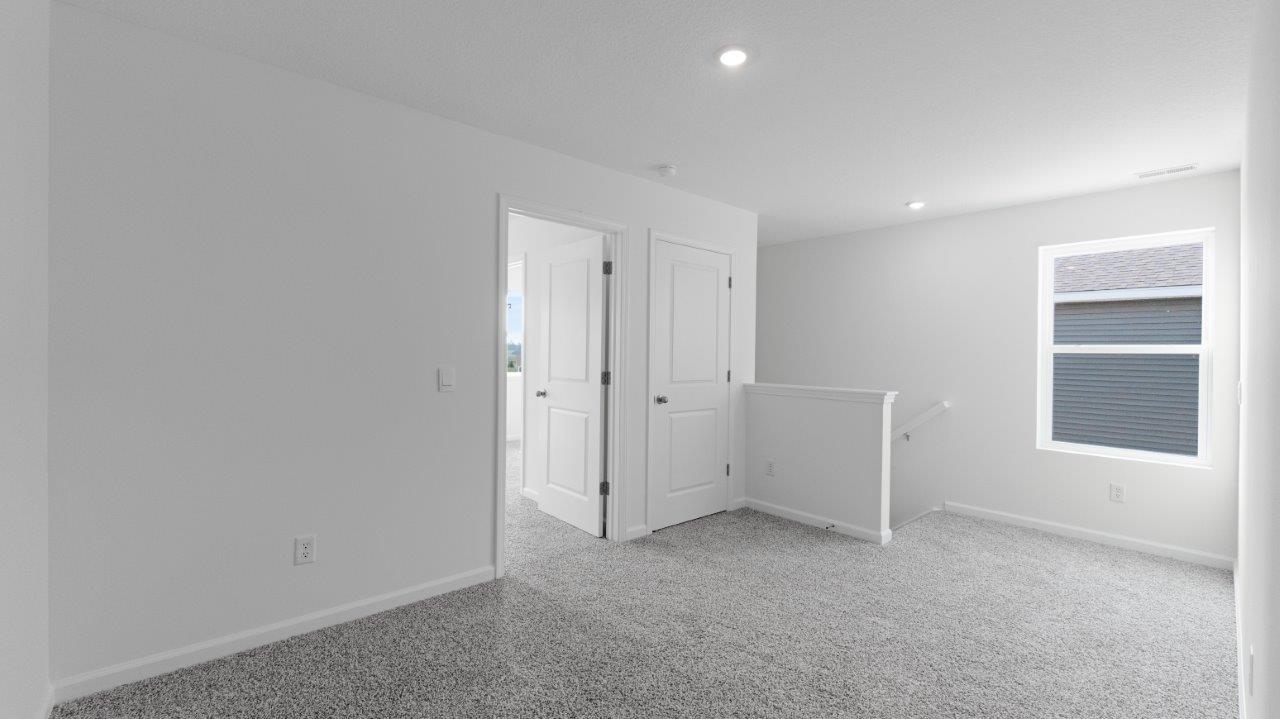 elm second floor loft with carpet flooring