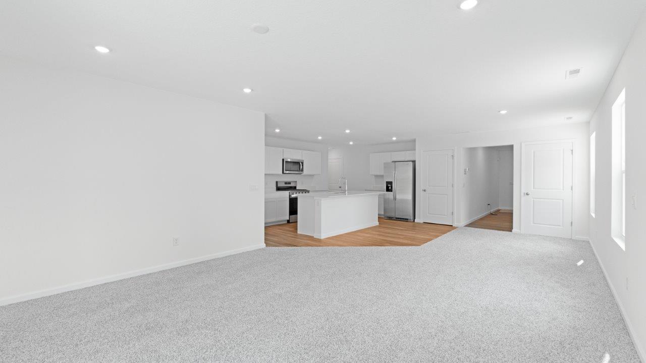 elm living room with carpet flooring and sliding door to backyard