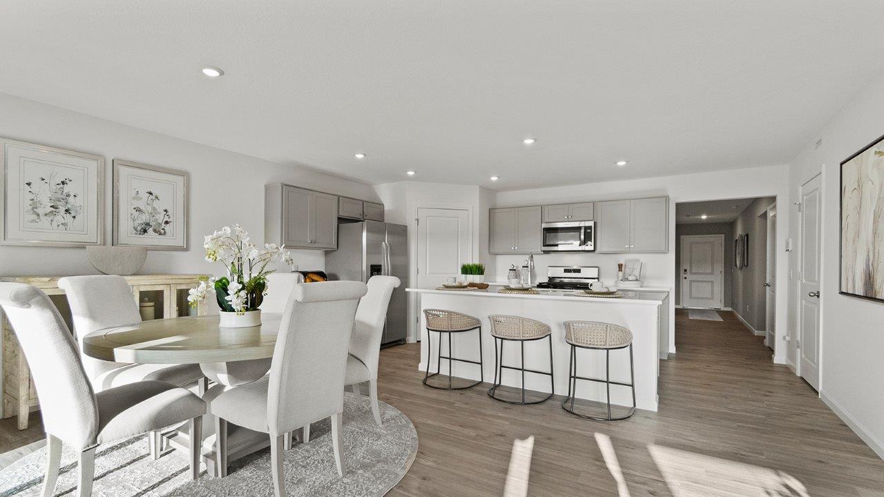 chatham dining room with lvp flooring and sliding glass door to backyard