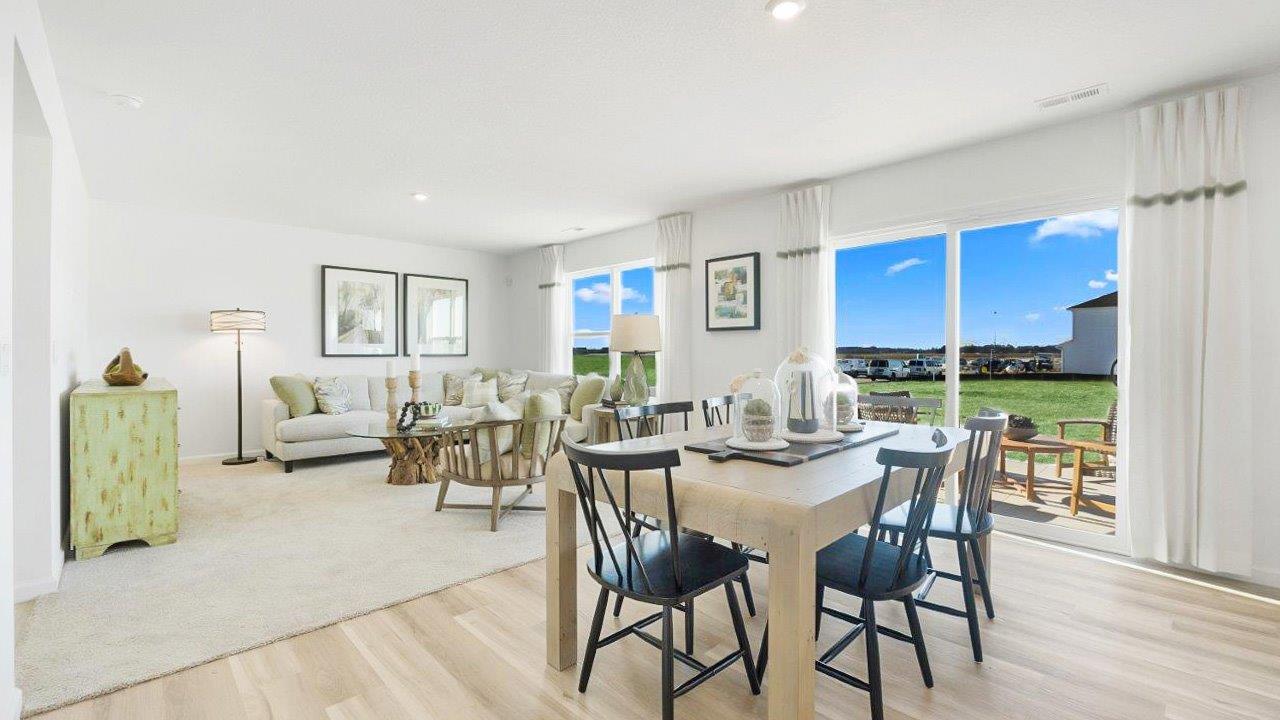 bellamy dining room with lvp flooring and sliding door leading to backyard