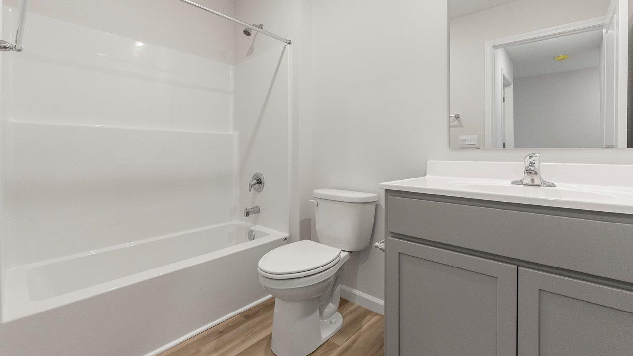 bathroom 2 with tub shower and single sink vanity