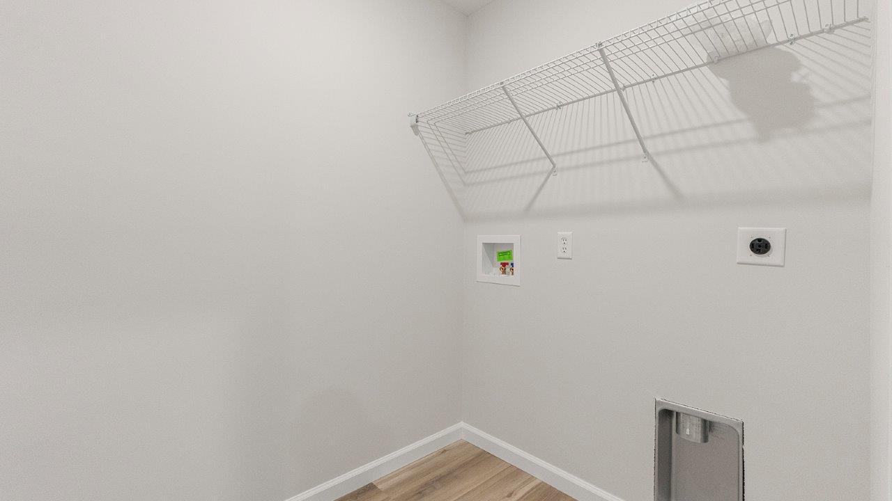 laundry room with lvp flooring, hookups for washer/dryer, and built-in shelving