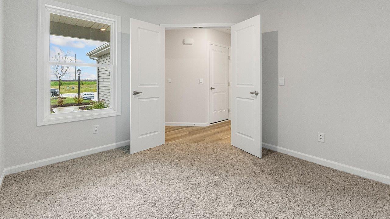 flex room with carpet and single window at front of home