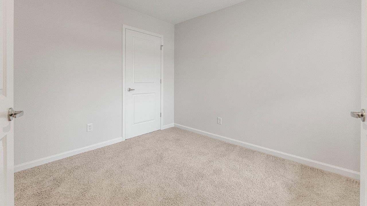 flex room with carpet and single window at front of home