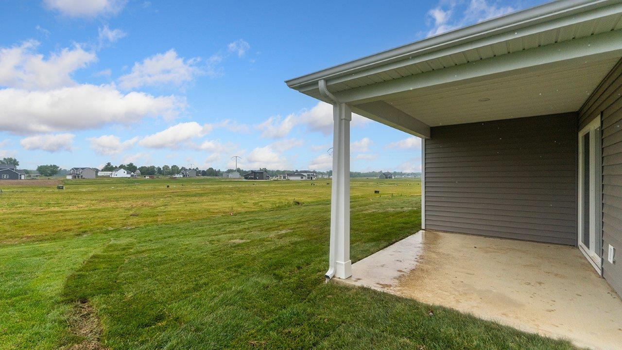 olsen exterior with backyard covered patio with sodded yard